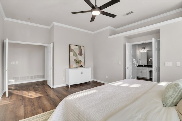 bedroom with crown molding, dark wood-type flooring, ceiling fan, and ensuite bath