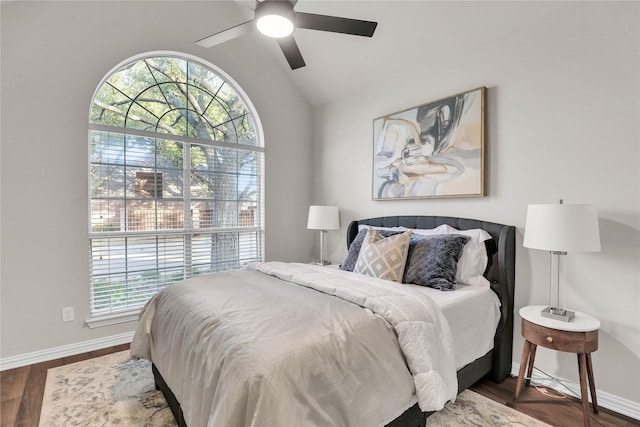 bedroom with ceiling fan, lofted ceiling, and dark hardwood / wood-style floors