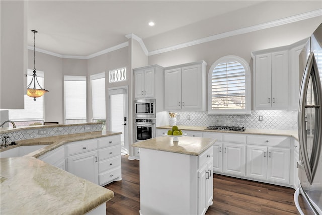 kitchen with sink, stainless steel appliances, a center island, and white cabinets