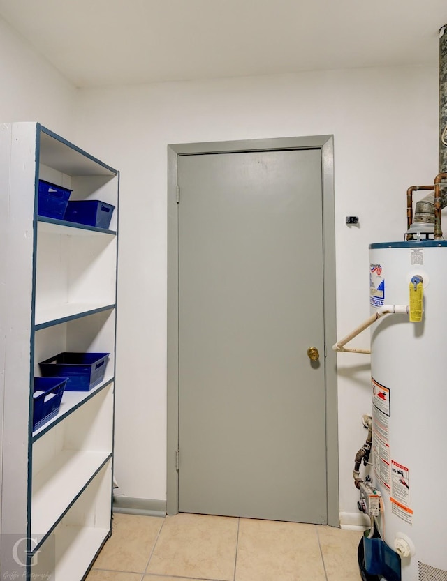 interior space with tile patterned flooring and gas water heater