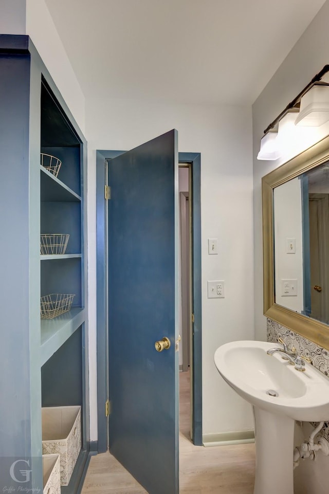 bathroom featuring wood-type flooring and built in features