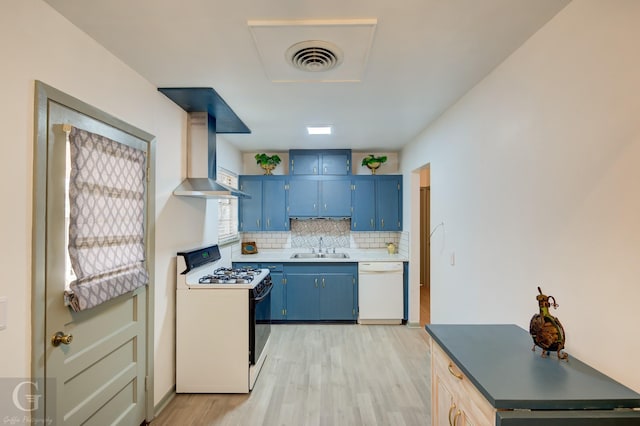 kitchen with blue cabinetry, wall chimney exhaust hood, light wood-type flooring, white appliances, and decorative backsplash