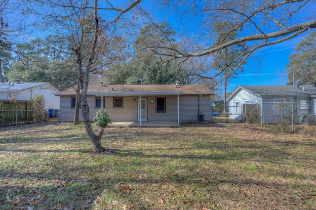 back of house with a patio, central AC unit, a lawn, and fence