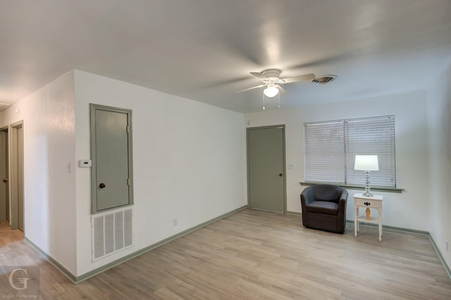 unfurnished room with ceiling fan and light wood-type flooring