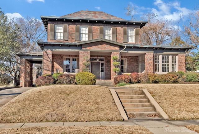 view of front of house with covered porch and a front lawn