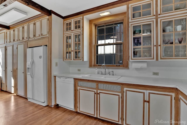 kitchen featuring ornamental molding, sink, white appliances, and light wood-type flooring