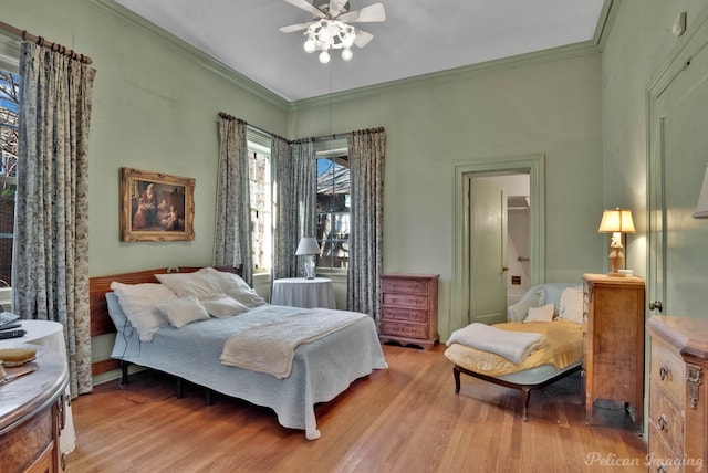 bedroom with crown molding, ceiling fan, and light wood-type flooring