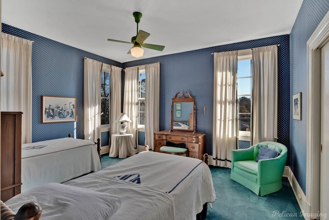 bedroom with a baseboard heating unit, carpet floors, and ceiling fan