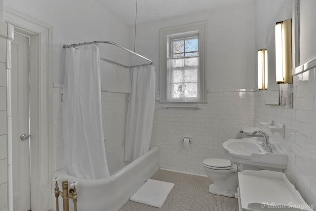 full bathroom with toilet, sink, tile walls, shower / bath combo with shower curtain, and tile patterned flooring