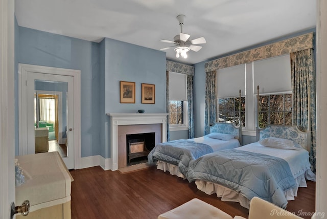 bedroom with dark hardwood / wood-style flooring and ceiling fan