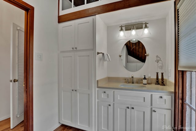 bathroom with vanity and hardwood / wood-style floors