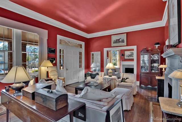 living room with hardwood / wood-style flooring and crown molding