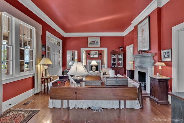 living room with hardwood / wood-style flooring and ornamental molding