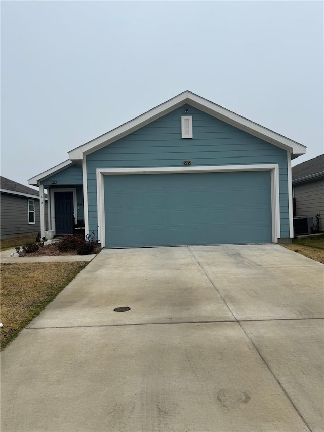 single story home featuring a garage and central AC unit