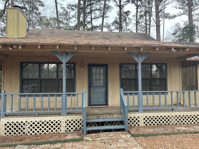 view of exterior entry with a porch