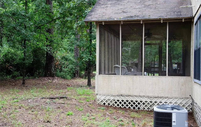 view of yard with a sunroom and central air condition unit