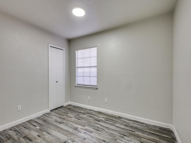 empty room with light hardwood / wood-style flooring