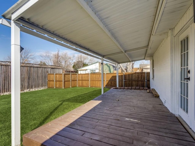 wooden terrace featuring a lawn