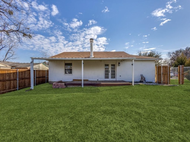 back of property featuring french doors and a yard