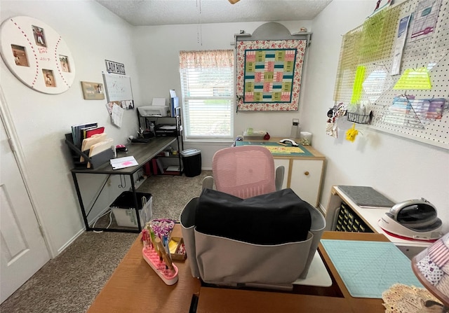 home office with carpet and a textured ceiling