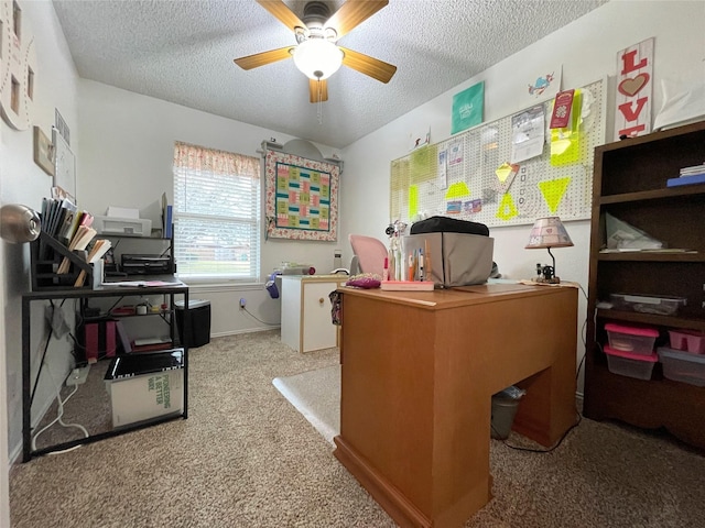 office space with carpet, a textured ceiling, and ceiling fan