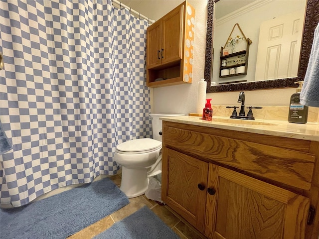 bathroom featuring vanity, crown molding, tile patterned floors, and toilet