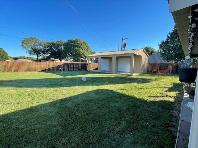 view of yard with a garage and an outdoor structure