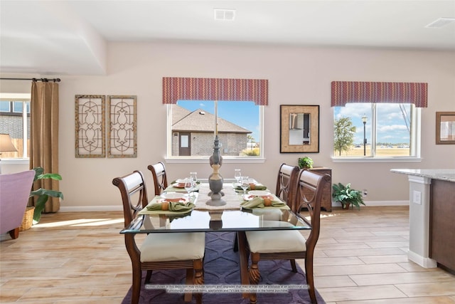 dining space with a wealth of natural light and light hardwood / wood-style floors