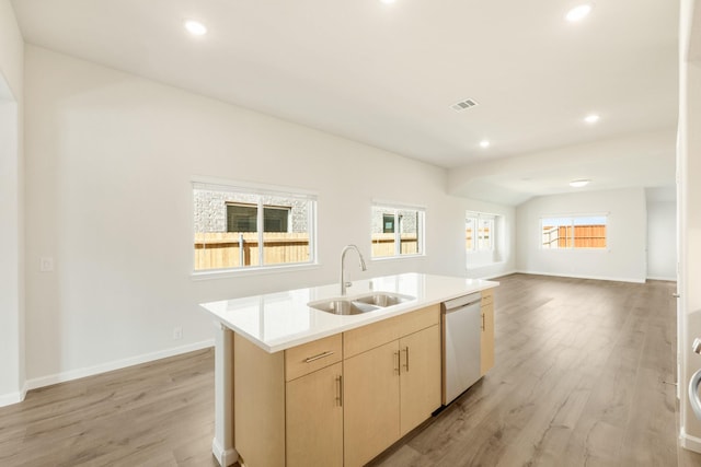 3219 Blossom Trl, Crandall, TX 75114 - kitchen with a sink, white dishwasher, light wood-type flooring, light brown cabinets, and light countertops