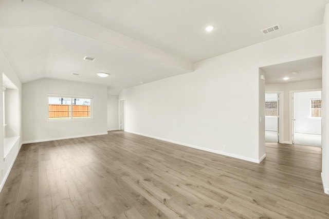 3219 Blossom Trl, Crandall, TX 75114 - spare room featuring wood finished floors, baseboards, lofted ceiling, and recessed lighting