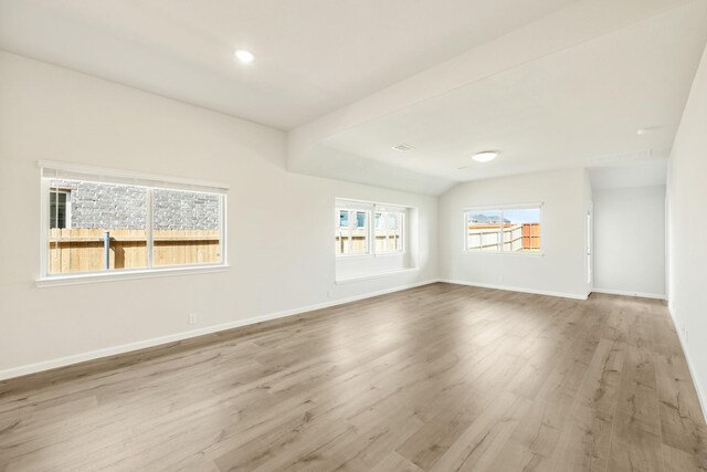3219 Blossom Trl, Crandall, TX 75114 - unfurnished living room with wood finished floors, baseboards, and vaulted ceiling