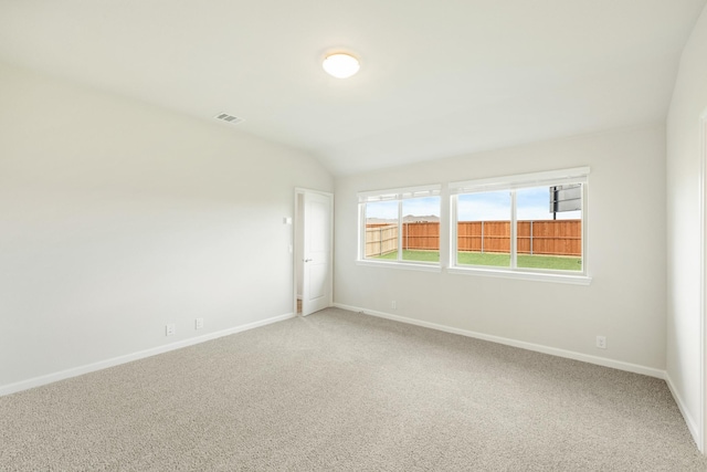 3219 Blossom Trl, Crandall, TX 75114 - empty room with light colored carpet, baseboards, and vaulted ceiling