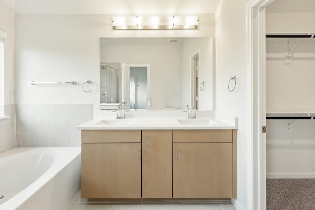 3219 Blossom Trl, Crandall, TX 75114 - bathroom with a bath, double vanity, a walk in closet, and a stall shower