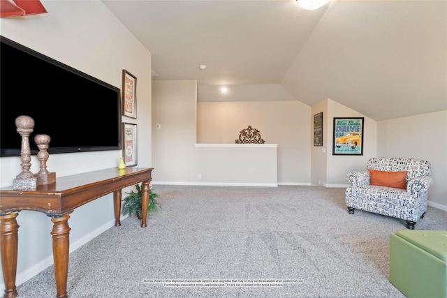 sitting room with vaulted ceiling and carpet flooring