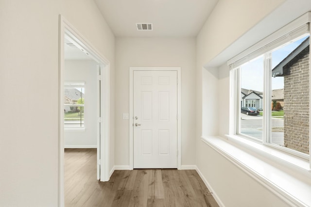 3219 Blossom Trl, Crandall, TX 75114 - doorway to outside with wood finished floors, healthy amount of natural light, and baseboards
