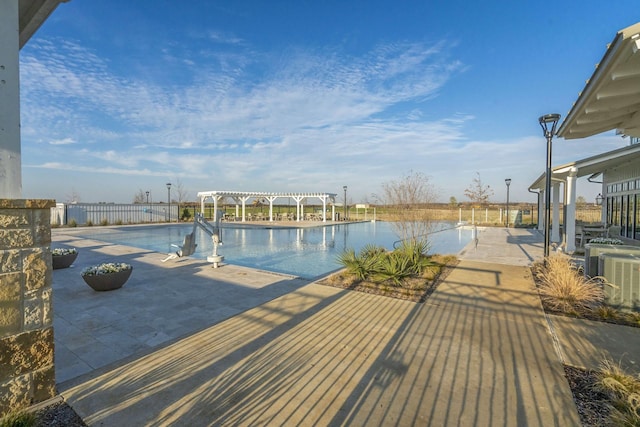 view of swimming pool featuring central AC, a patio area, and a pergola