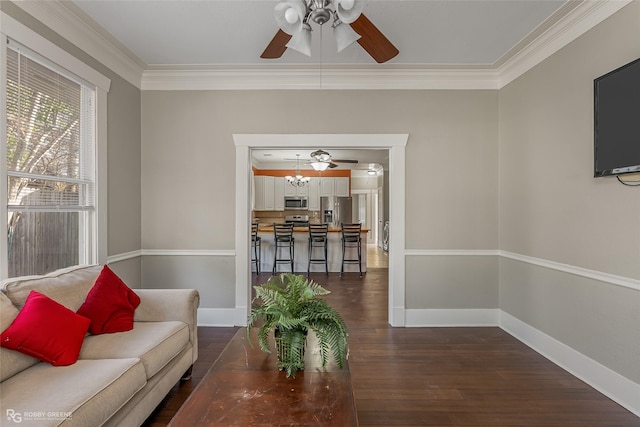 living room featuring ornamental molding, ceiling fan, and dark hardwood / wood-style flooring