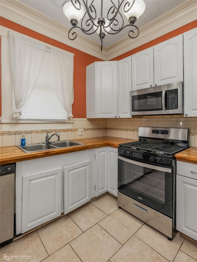 kitchen featuring wood counters, sink, white cabinets, and appliances with stainless steel finishes