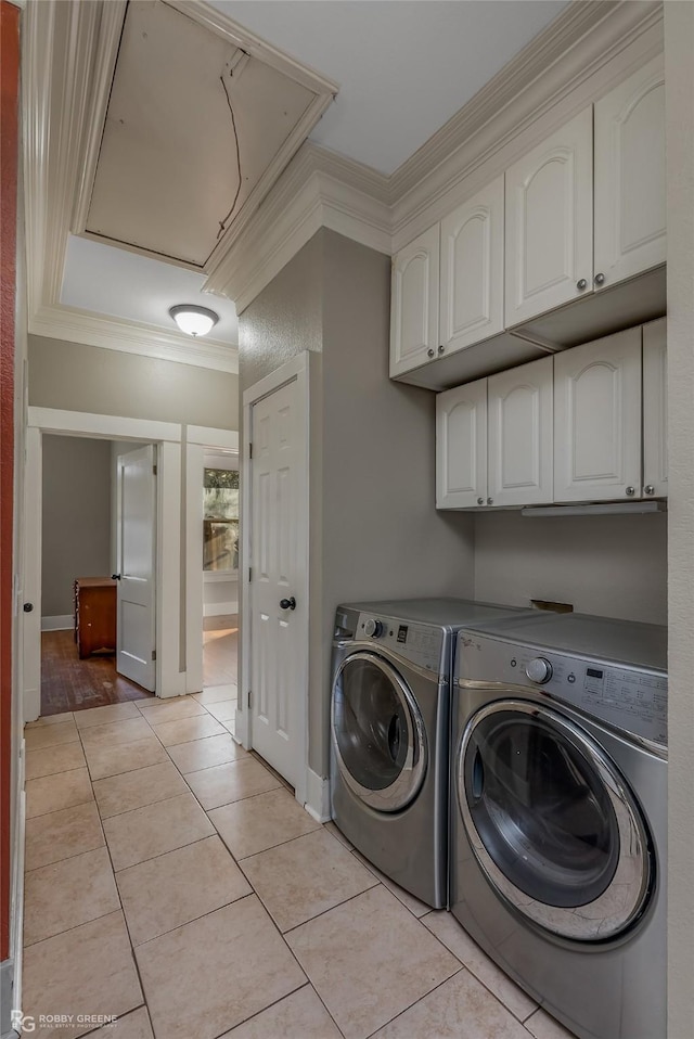 laundry room with cabinets, crown molding, independent washer and dryer, and light tile patterned flooring