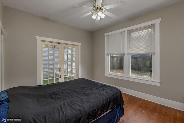 bedroom featuring dark wood-type flooring, ceiling fan, and french doors