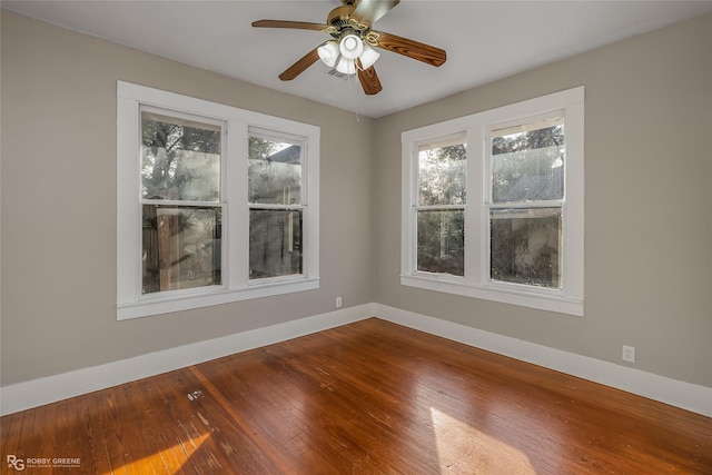 empty room with hardwood / wood-style flooring and ceiling fan