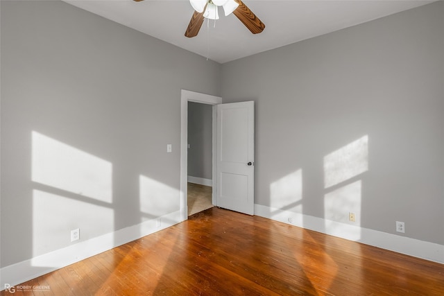 spare room with hardwood / wood-style floors and ceiling fan