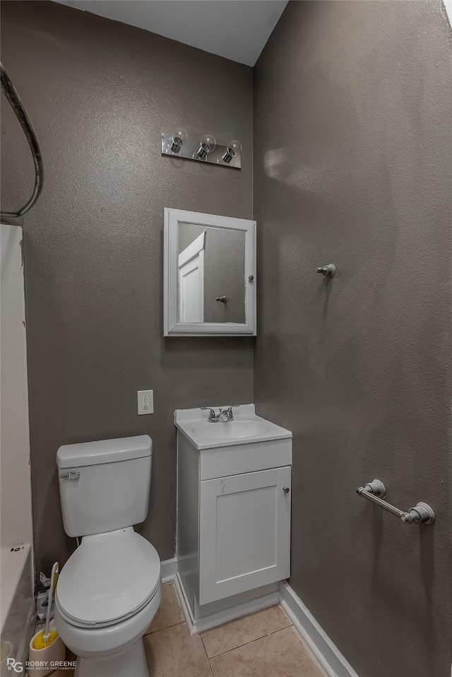 bathroom with vanity, toilet, and tile patterned flooring