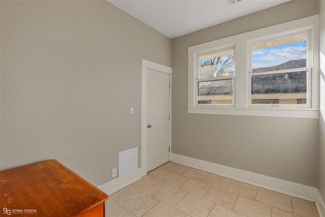 unfurnished room featuring light tile patterned floors