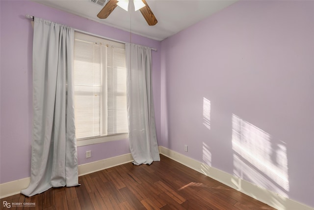 spare room featuring dark hardwood / wood-style floors and ceiling fan