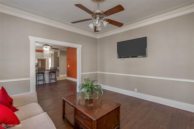 living room with dark wood-type flooring, ceiling fan, and ornamental molding