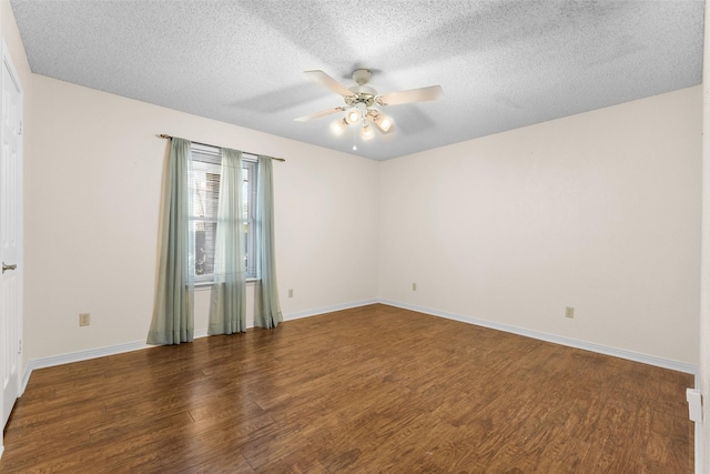 empty room with ceiling fan, a textured ceiling, and dark hardwood / wood-style flooring