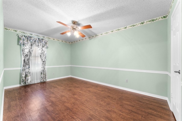 empty room featuring ceiling fan, dark hardwood / wood-style flooring, and a textured ceiling