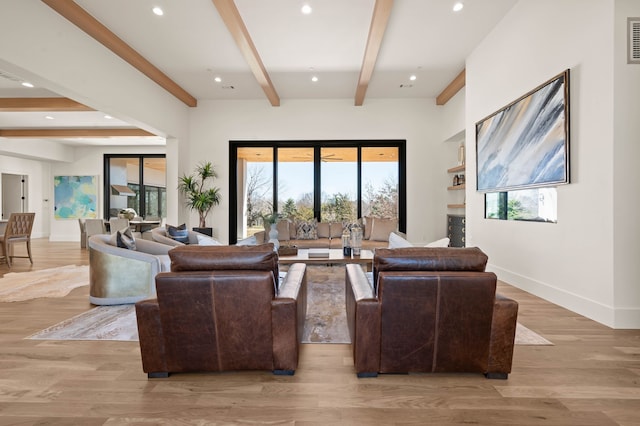 living room featuring recessed lighting, beamed ceiling, baseboards, and light wood-style floors