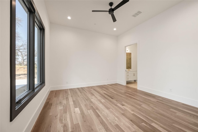 spare room featuring visible vents, a ceiling fan, recessed lighting, light wood-style floors, and baseboards